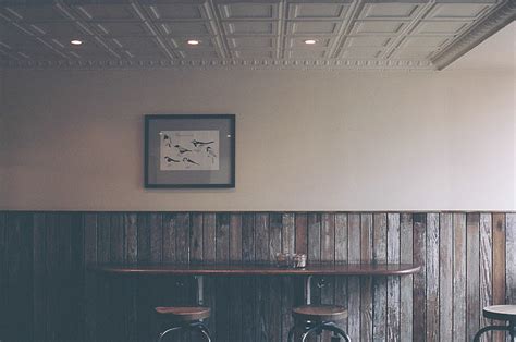 Royalty-Free photo: Brown wooden table with two chairs beside the wall located inside the room ...