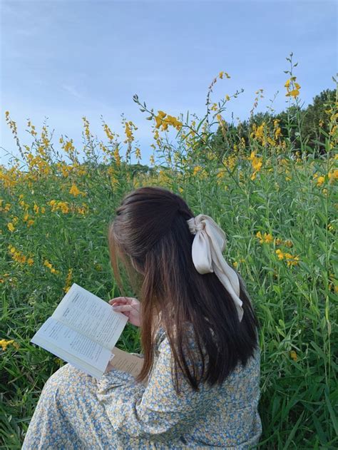 Girl sitting in field reading a book. | Nature aesthetic, Girl reading, Aesthetic images