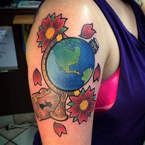 a woman with a tattoo on her arm has a globe and flowers around it,