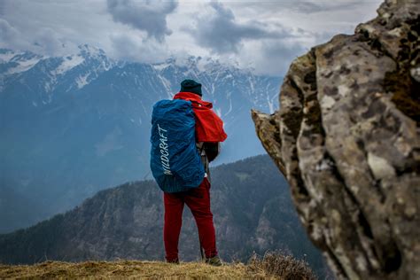 Man Wearing Blue Hoodie Standing on Top of Mountain · Free Stock Photo