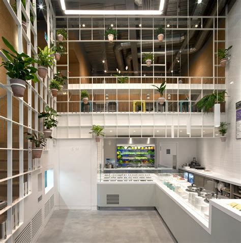 Pot plants cover trellis-like walls inside London cafe by Neiheiser ...