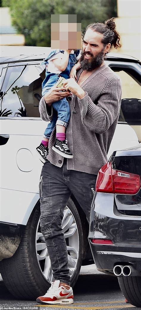 Russell Brand, 43, looks ever the doting dad as he holds daughter Mabel ...