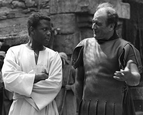 Sidney Poitier with a toupee-less John Wayne on the set of THE GREATEST ...