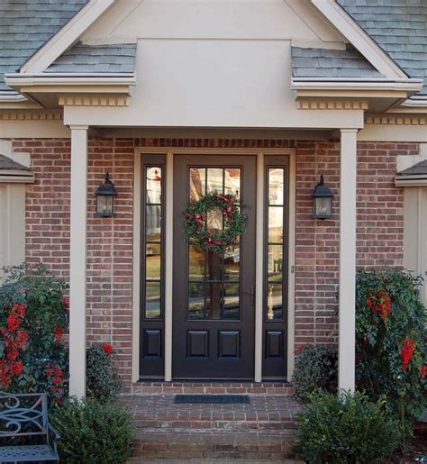 Black front door with glass & wreath. Sidelights. Red brick house with ...