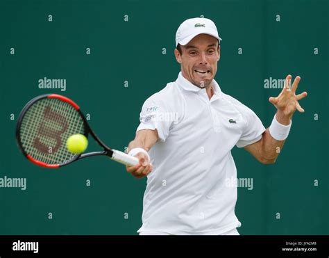 ROBERTO BAUTISTA AGUT in action at Wimbledon Stock Photo - Alamy