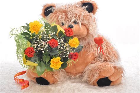 Flowers and a teddy bear stock photo. Image of collection - 39817824