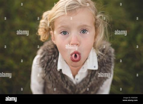 Portrait of young girl, curling tongue Stock Photo - Alamy