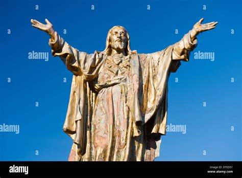 Weathered statue of Jesus Christ with outstretched arms Stock Photo - Alamy