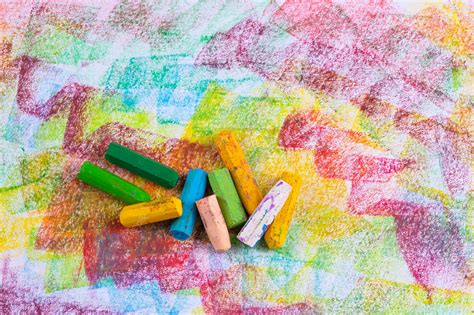 Premium Photo | Colorful pastel crayons with painting background