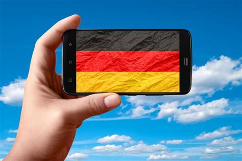 Premium Photo | Germany flag on the phone screen smartphone in hand ...