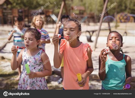 Schoolkids playing with bubble wand Stock Photo by ©Wavebreakmedia 154963284