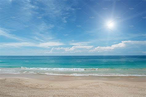 Sandy beach and sun in blue sky | Background Stock Photos ~ Creative Market