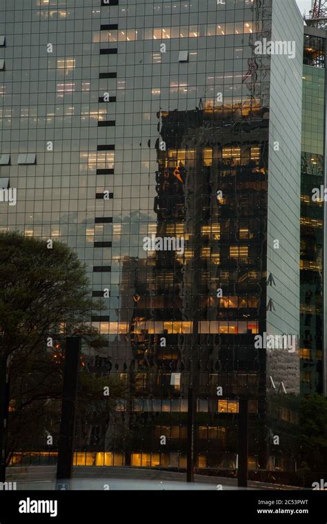 Glass building facade with building reflextions at night Stock Photo - Alamy