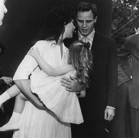 Marlon Brando pictured with his (then) wife and daughter.