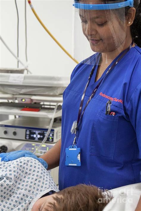 Nurse During An Endoscopy Examination Photograph by Life In View/science Photo Library