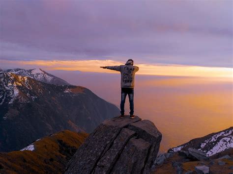 Man On A Cliff During Sunset · Free Stock Photo