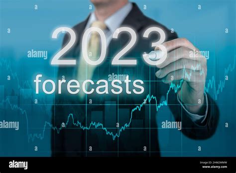 Economic forecasts for 2023. businessman writes forecasts for 2023 on ...