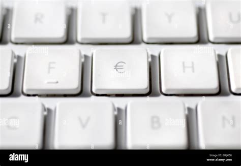 Euro sign on laptop computer keyboard Stock Photo - Alamy