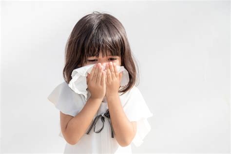 Premium Photo | Asian child girl sick with sneezing on the nose and ...