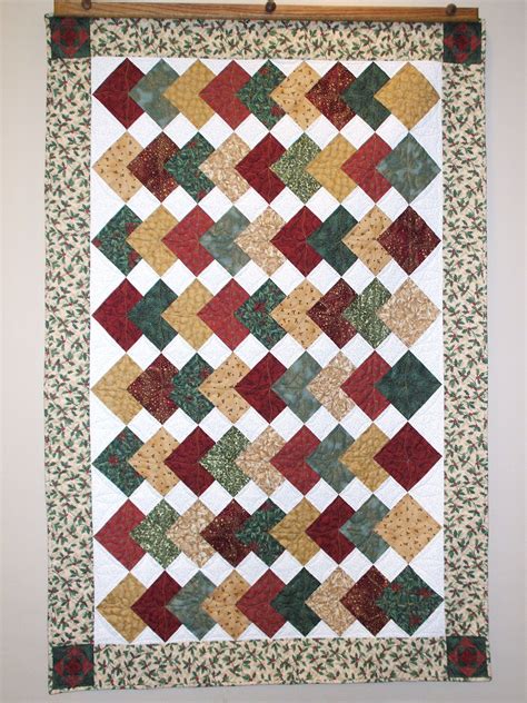 Card trick patchwork quilt in Christmas colors. Machine quilted using a holly leaf pattern ...