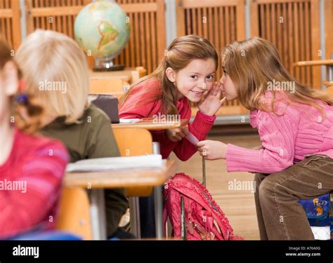 Girls talking in class Stock Photo - Alamy