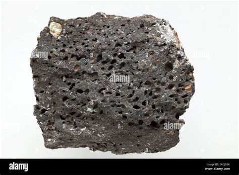 Vesicular basalt (scoria). Basalt is an extrusive (volcanic) igneous rock composed of feldspar ...