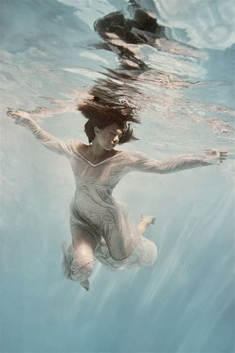 Girl with Dark Hair in a Light Blue Dress Underwater Stock Image - Image of floating, girl ...