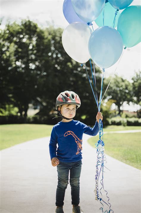 LITTLE BOY HOLDING BALLOONS | Balloon shop, Balloons, Number balloons