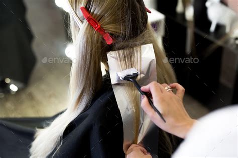 Process of dyeing hair at beauty salon. Stock Photo by StudioPeace