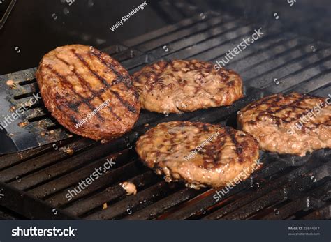 Flipping A Burger On A Barbecue With A Spatula. Stock Photo 25844917 : Shutterstock