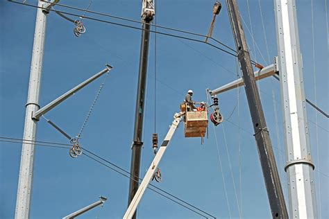 High Voltage Power Line Construction Photograph by Jim West - Fine Art ...