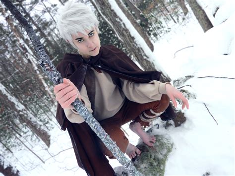 a woman with white hair is holding onto a pole in the snow while ...