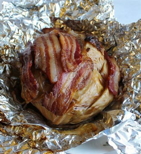 A whole head of cabbage wrapped in bacon and braised in beer is a thing of glory. Make it on the ...