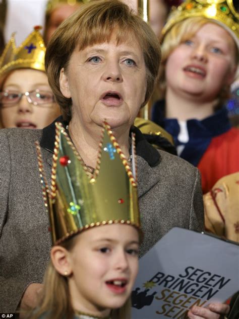 German chancellor Angela Merkel courts international controversy by posing for photos alongside ...