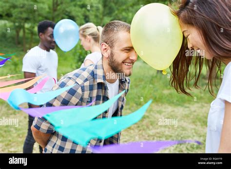 Friends play air balloon dance together outdoors in summer Stock Photo ...