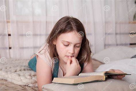 Teenage Girl Lying on Bed and Reading Book Stock Image - Image of ...