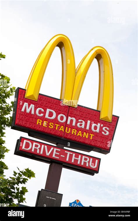 McDonald's sign and company logo on post with drive-thru sign at West Stock Photo, Royalty Free ...