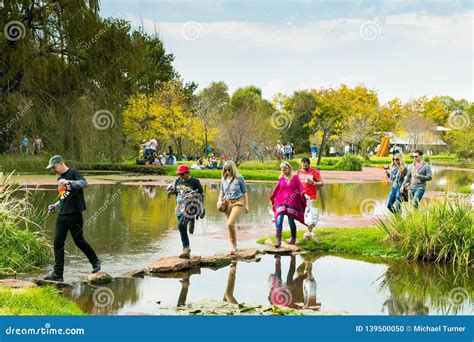 Diverse People Crossing a Lake at Outdoor Festival Editorial Image ...