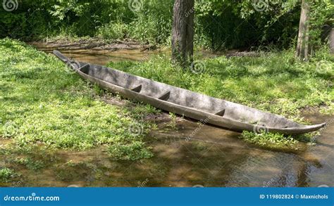 Dugout canoe on river bank stock photo. Image of grass - 119802824