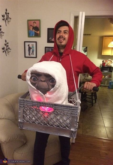 a man in a red hoodie holding a basket with a stuffed animal inside