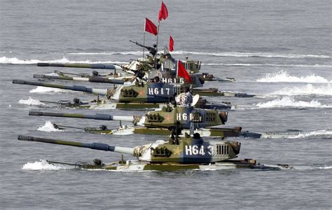 Amphibious tanks of the Chinese People's Liberation Army move to land a beach during the second ...