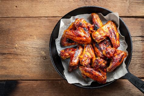 Premium Photo | Baked chicken wings in barbecue sauce.