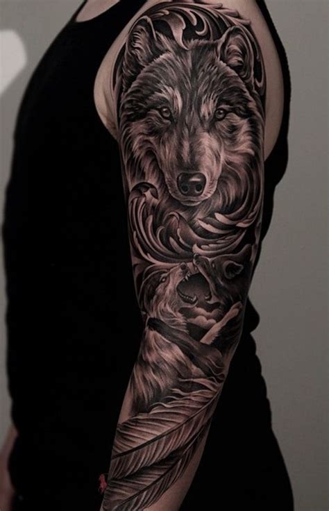 A majestic looking sleeve tattoo. The tattoo shows a face of a wolf who is seemingly ready for ...