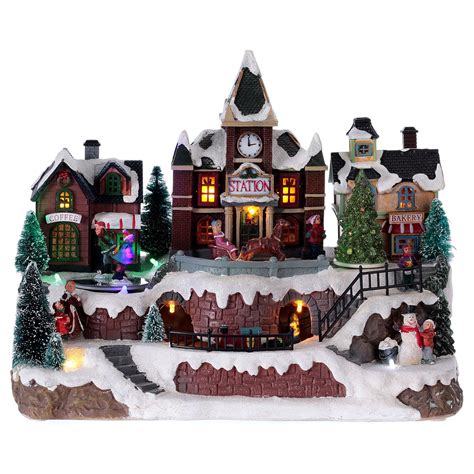 Animated musical Christmas village with train and iced lake | online ...