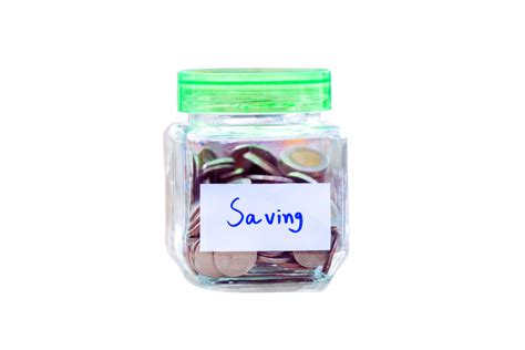Transparent glass jar with green lid, filled with coins and labeled 'Saving', symbolizing ...