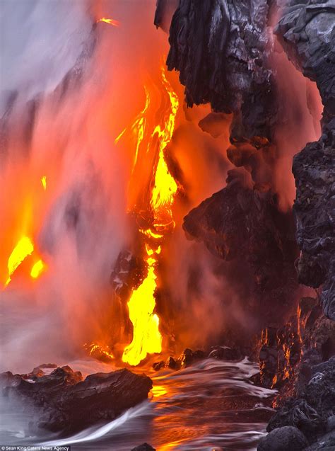 Fire and lava spew from Hawaiian volcano in extraordinary images that look like scenes from ...