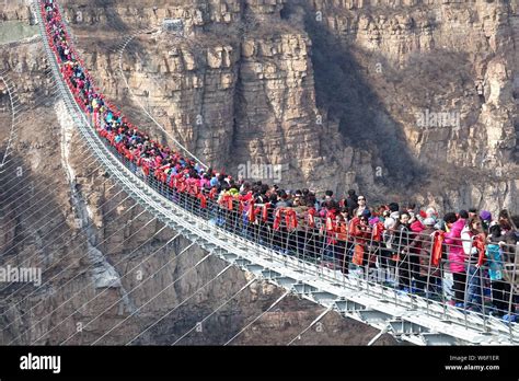 Tourists throng to walk on the world's longest glass bridge in the Hongyagu Scenic Area in ...