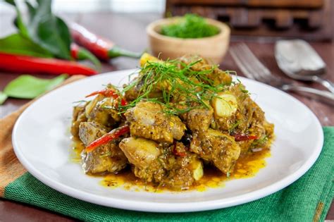 Premium Photo | Fried pork bones spicy with yellow curry paste on dish thai style food