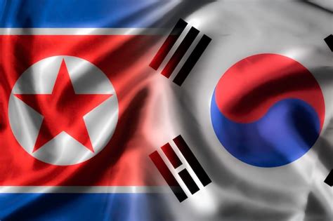 Premium Photo | Waving of north and south korea for politic and military war conflict from both ...