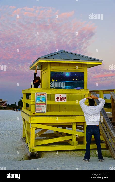 Siesta Key Beach lifeguard tower with couple exercising at sunset in Sarasota, Florida Stock ...